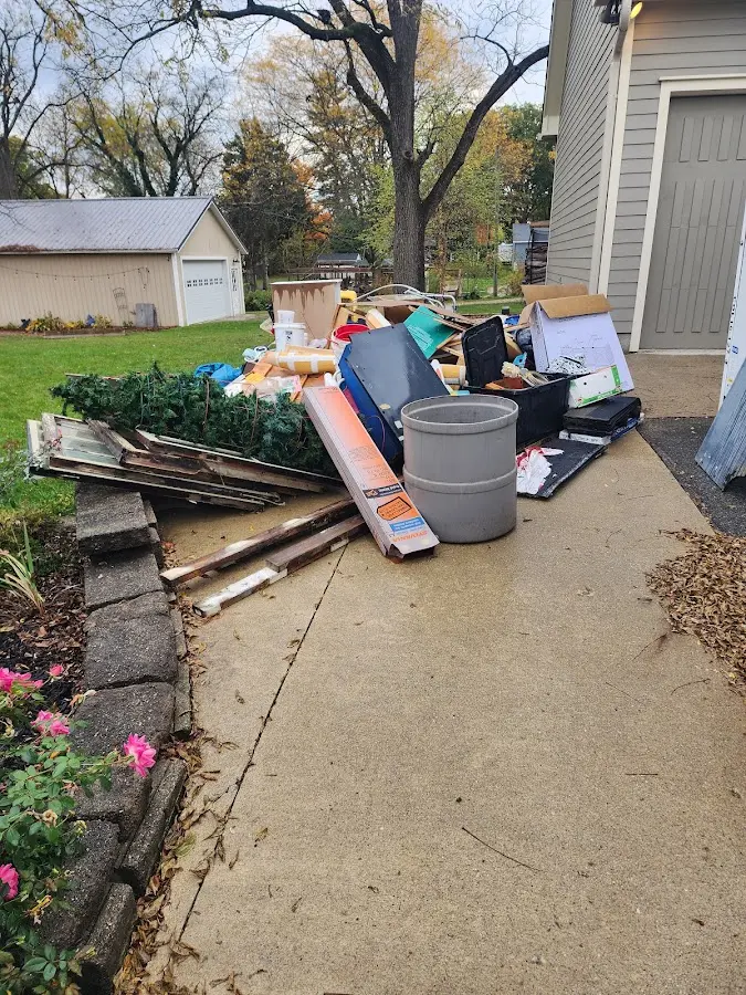 Dumpster being loaded with debris for Estate Cleanout Dumpster Rental in Fountainebleau